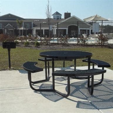 a picnic table and benches in a park