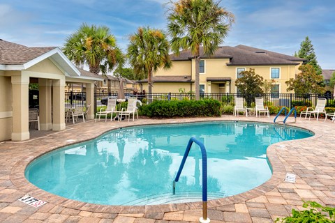 A pool with a blue ladder in the middle of it.