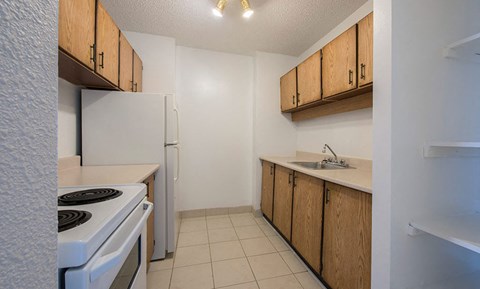 a kitchen with a stove and a refrigerator