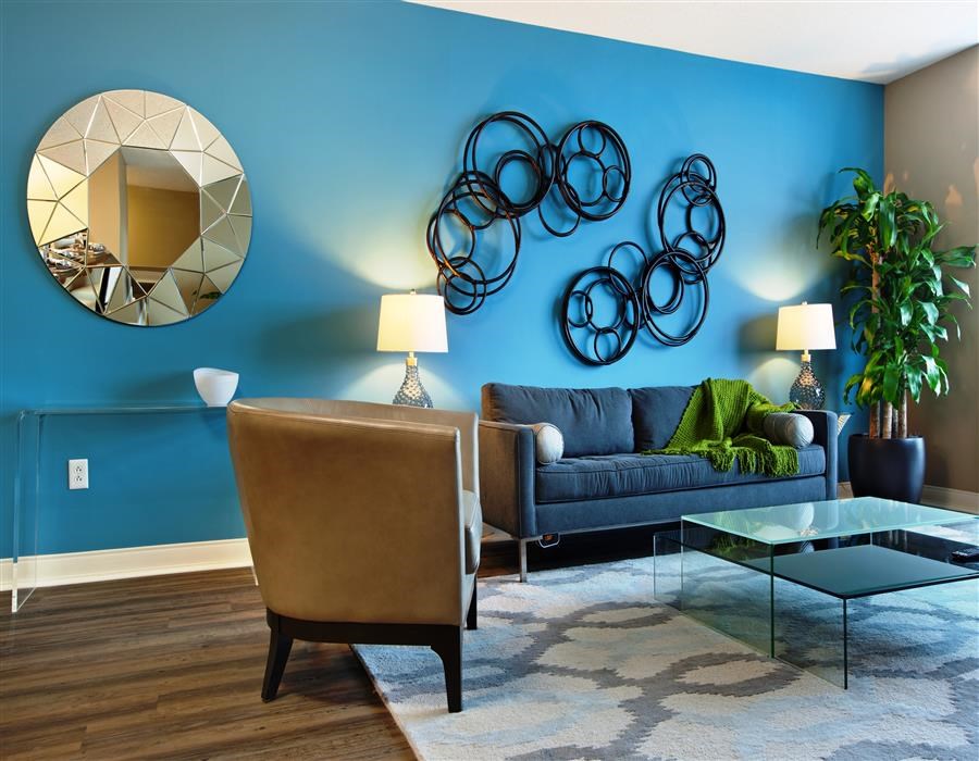 a living room with a blue wall and a blue couch