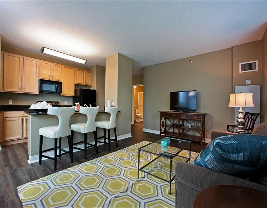 a living room and kitchen with a table and chairs