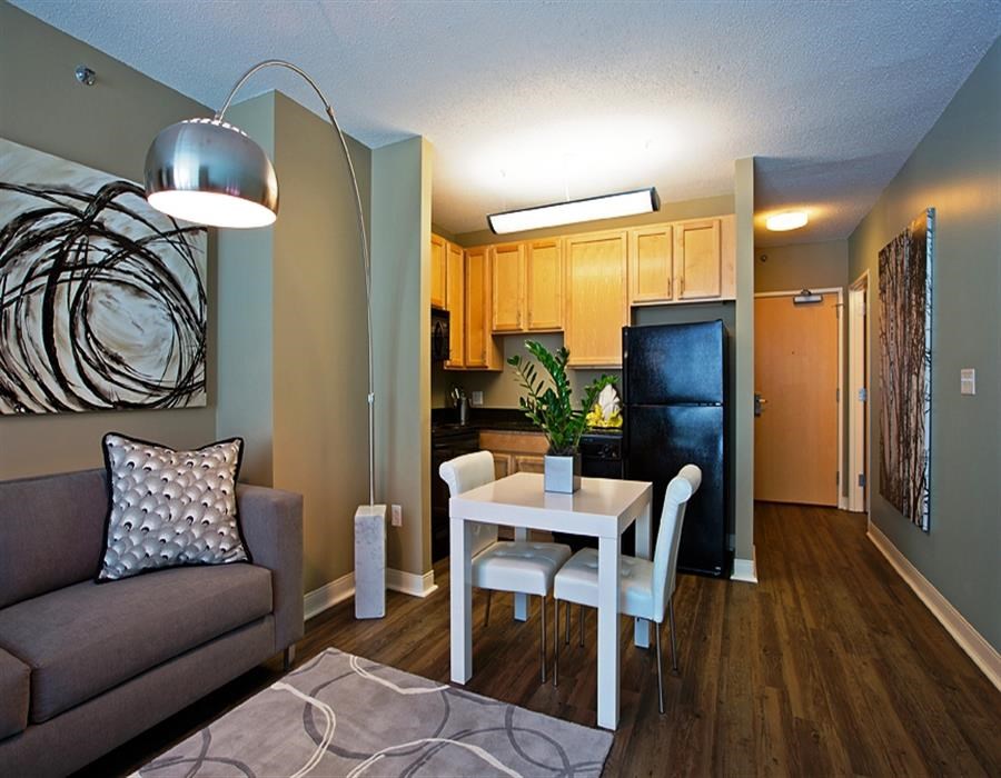 a living room and kitchen with a table and a couch