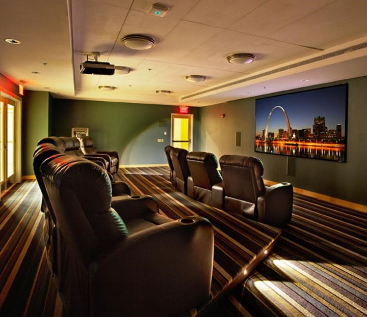 a large living room with leather chairs and a tv