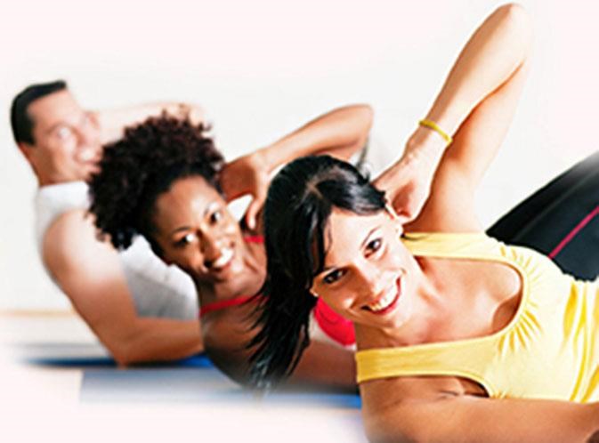 three people laying on top of each other on the floor