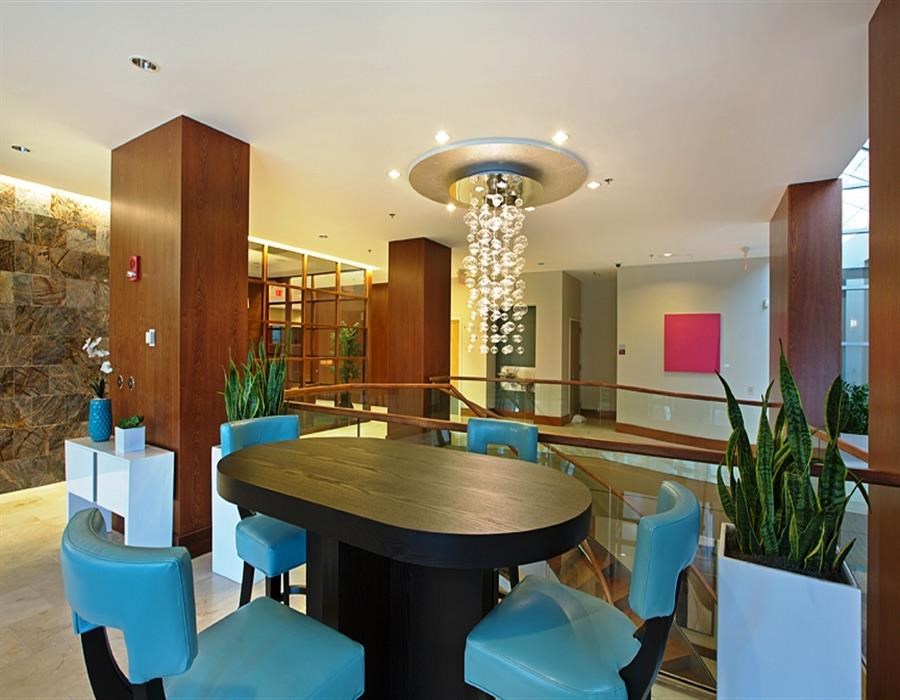 a dining room with a table and chairs and a chandelier