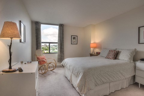 a bedroom with a bed and a window