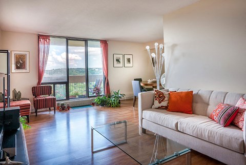 a living room with a white couch and a glass table