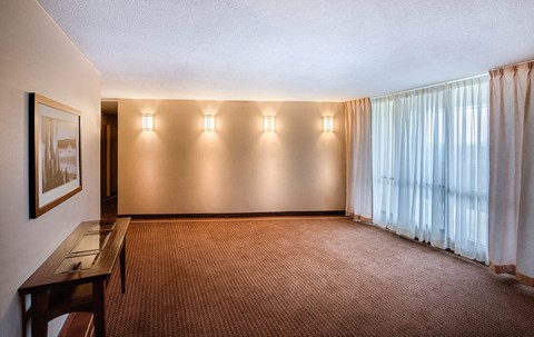 a living room with curtains and a window and a table