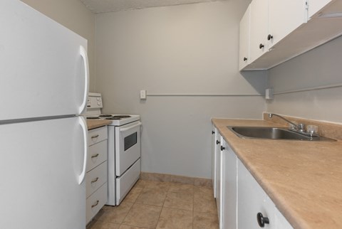 a kitchen with a sink stove and refrigerator