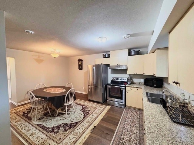 A kitchen with a table and chairs in the middle of the room.