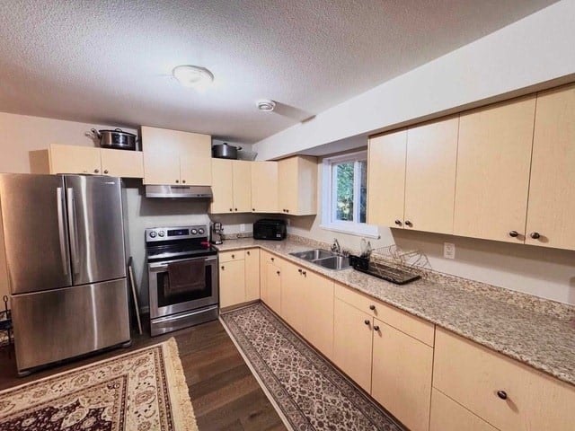 A kitchen with wooden cabinets and a granite countertop.