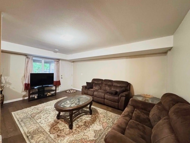 A living room with a brown couch, a coffee table, and a fireplace.