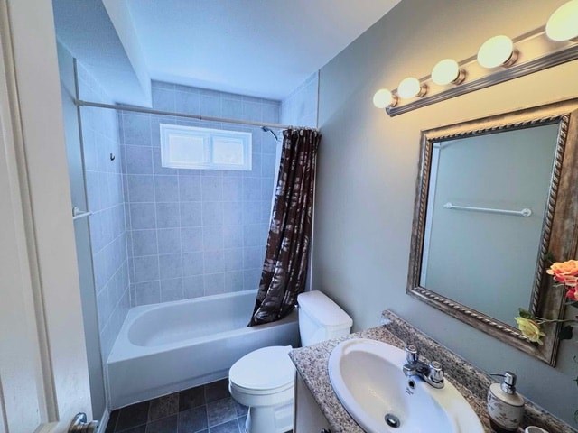 A bathroom with a white toilet, a bathtub with a shower curtain, a sink, and a mirror.