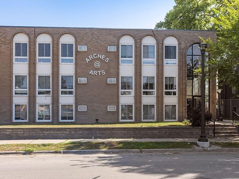 A building with the words "Arches @ Arts" on it.