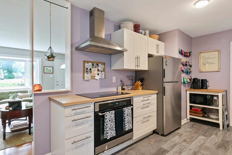 A kitchen with a stove top oven and a refrigerator.