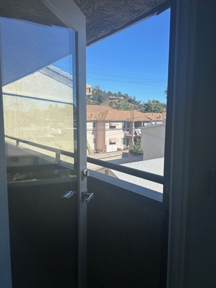 A view from a window looking out at a residential area.