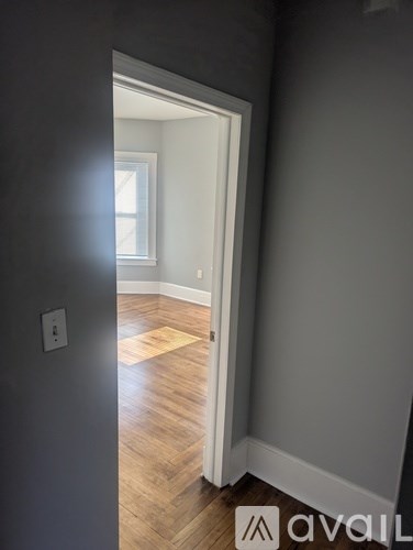 A room with a wooden floor and a white door.
