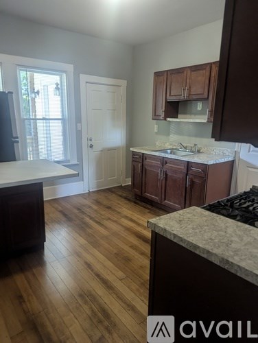 A kitchen with wooden floors and a counter top.
