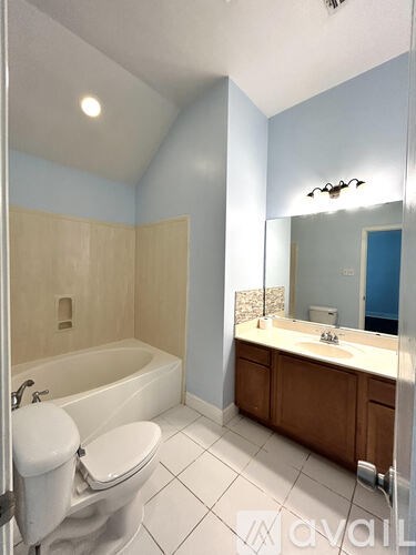 A bathroom with a white toilet and a white sink.