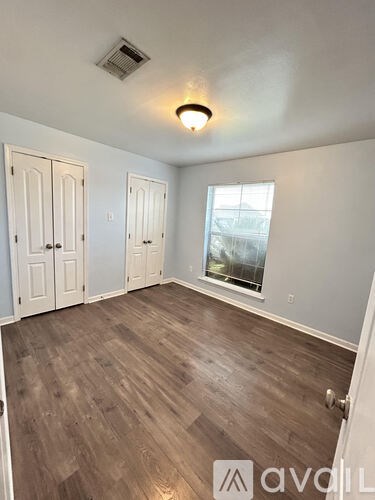 A room with wooden floors and white walls.