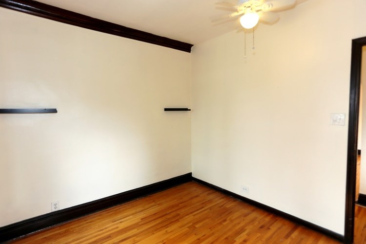 A room with wooden floors and white walls.