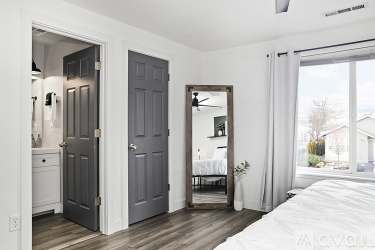 A bedroom with a large bed and a mirror on the wall.