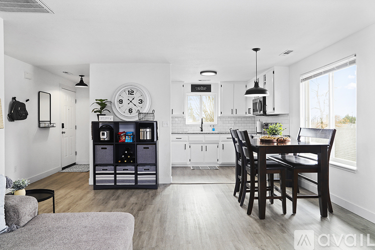 A modern kitchen with a dining table and chairs.