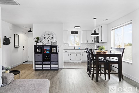 A modern kitchen with a dining table and chairs.