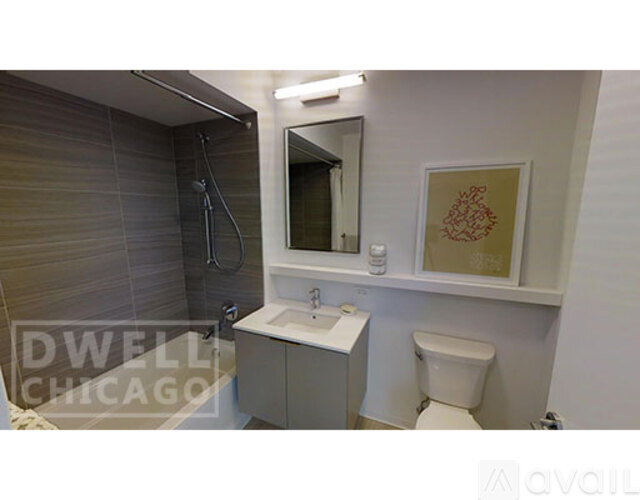 A small bathroom with a toilet, sink, and mirror.