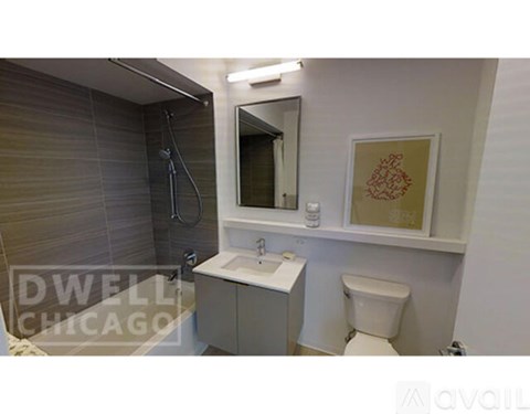 A small bathroom with a toilet, sink, and mirror.