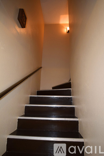 A staircase with a logo on the bottom step.