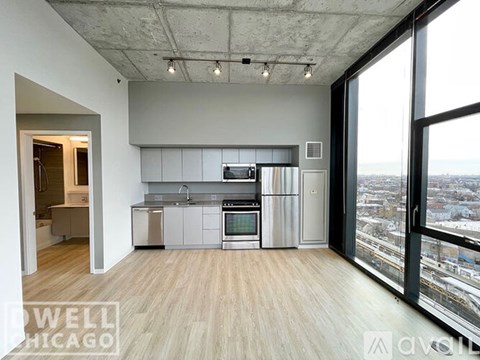 A modern kitchen with stainless steel appliances and a view of the city.