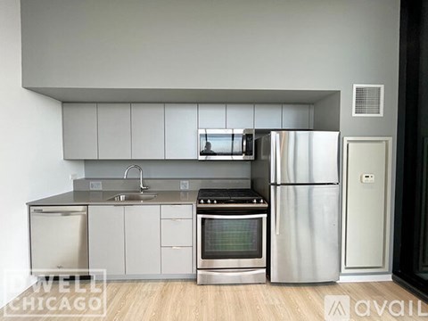 A modern kitchen with stainless steel appliances and white cabinets.