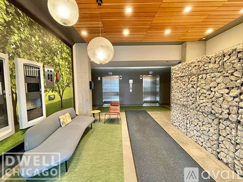 A modern living room with a stone wall and a green carpet.