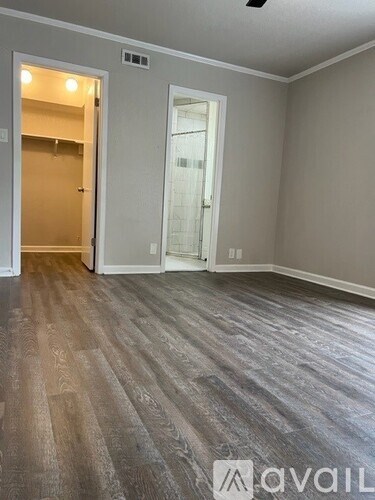 A room with a wooden floor and a ceiling fan.