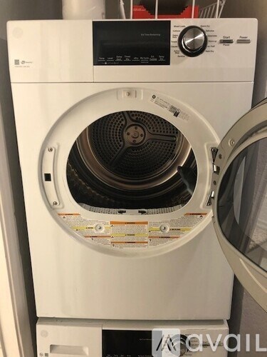 A white front loading washing machine with the door open.