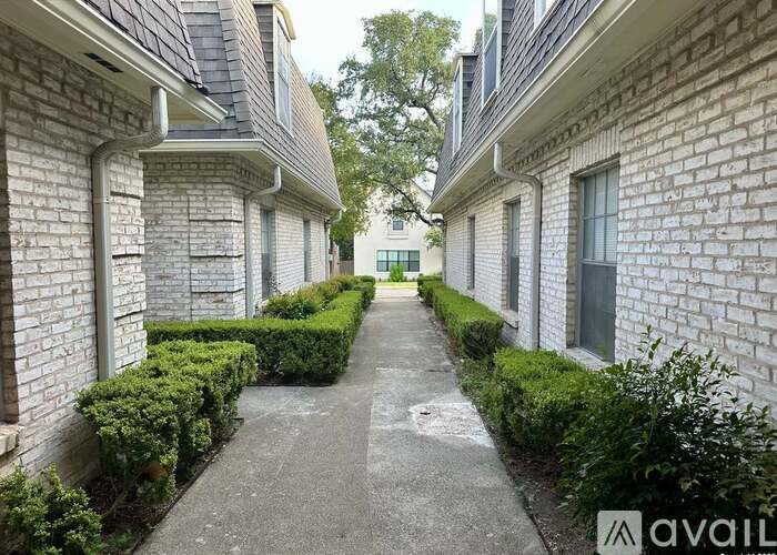 A long, narrow walkway separates two rows of houses.