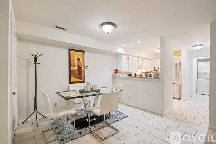 A dining room with a glass table and chairs.
