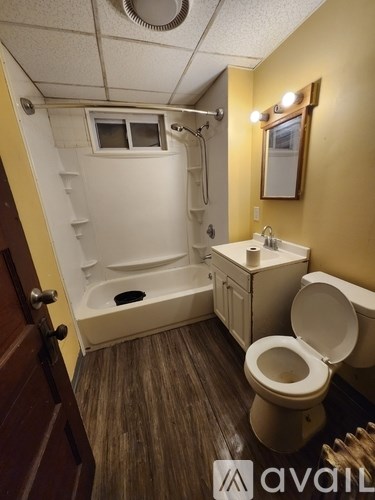 A bathroom with a toilet, sink, and bathtub.