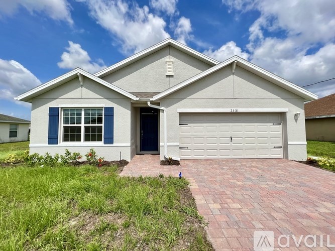A house with a garage and a driveway in front.