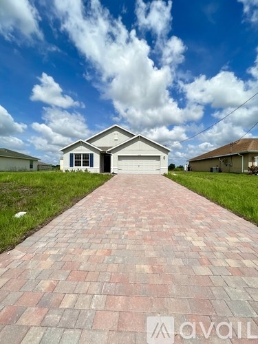 A house with a brick pathway leading to it.