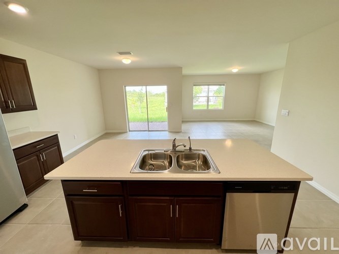 A kitchen with a sink and a window.