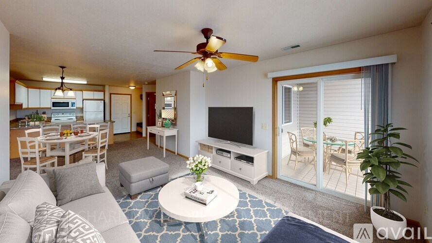A living room with a television, a couch, and a coffee table.