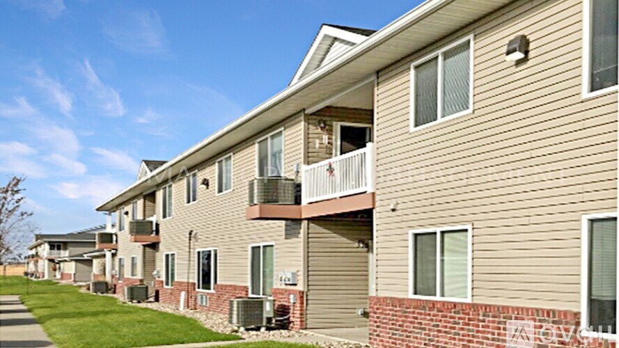 Apartment building with a balcony on the second floor.