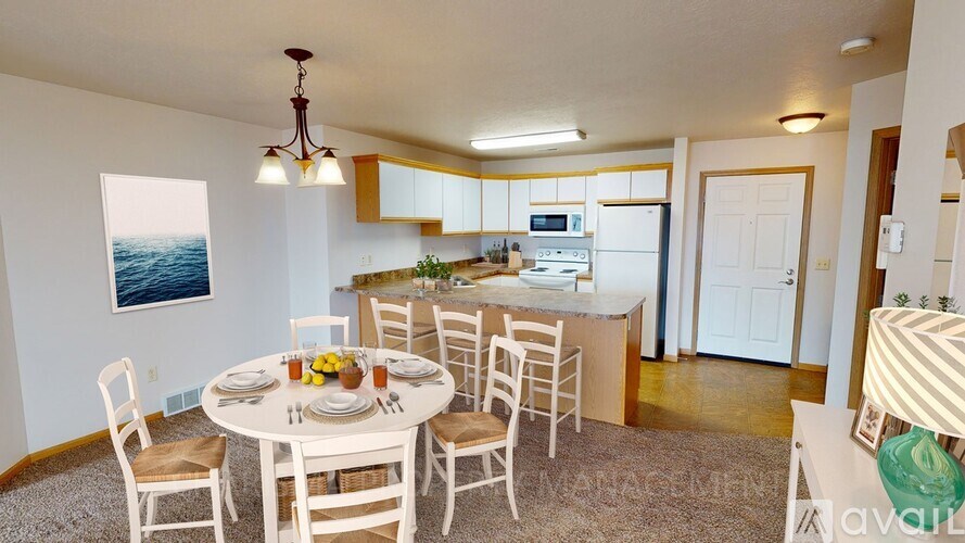 A dining room with a table set for four.