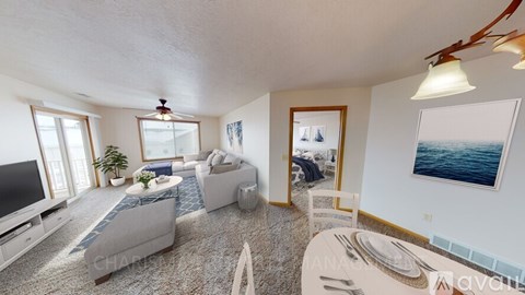 A living room with a grey sofa, a white coffee table, and a painting of a boat on the wall.