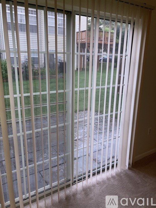 A view of a backyard through a sliding glass door.