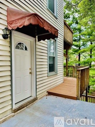 A house with a white door and a brown awning.
