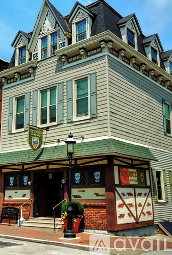 A building with a green roof and a sign that says "available" on the front.