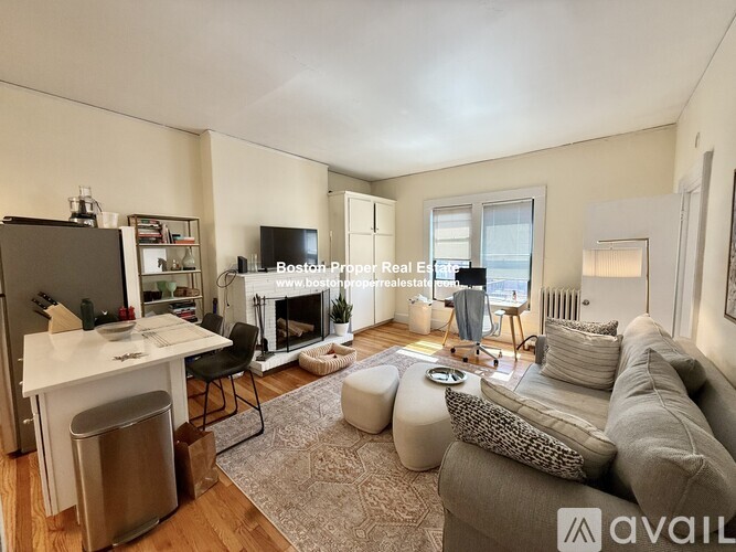 A living room with a fireplace and a television on the wall.